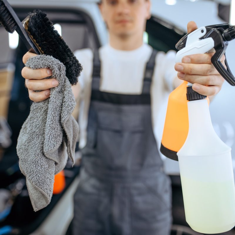 worker-shows-tools-for-dry-cleaning-and-detailing.jpg
